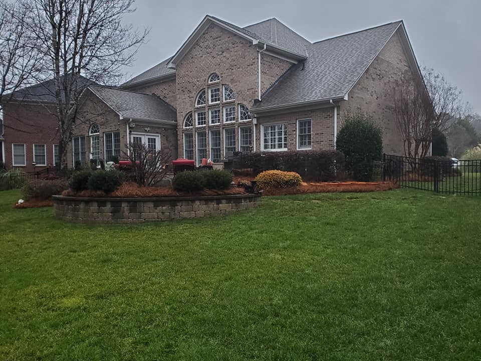 Landscaping project with retaining wall and manicured lawn